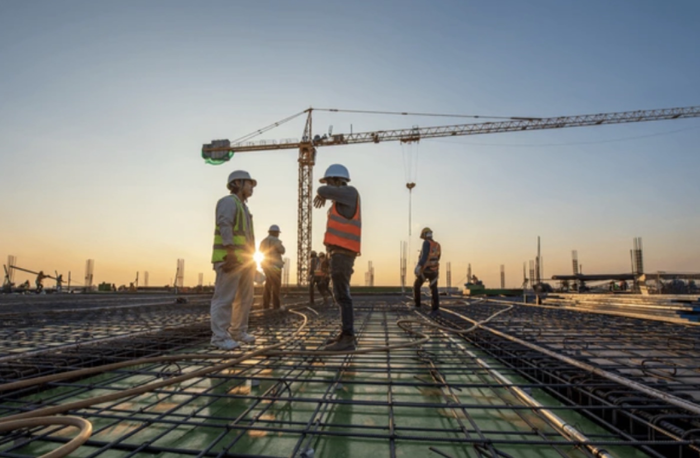 Deschampsconstructions crew working on a build site at dusk